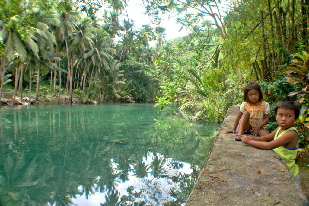 The tranquil Matutinao River, fed by the impressive Kawasan Falls, supports families living simple lives at Badian, Cebu.